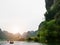 The boat that was paddling along the waterway with high mountains