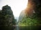 The boat that was paddling along the waterway with high mountains