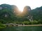 The boat that was paddling along the waterway with high mountains