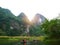 The boat that was paddling along the waterway with high mountains