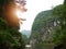 The boat that was paddling along the waterway with high mountains