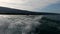 Boat white wake on the blue lake of Annecy, France