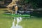 A Boater Standing in His Paddling Boat