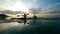 Boaters are kayaking along the sunset lake