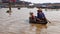 Boaters in river, Tonle Sap, Cambodia