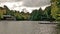 Boathouse nestled among the maple trees. Senior retire couple sitting on Muskoka chair enjoying the scenery