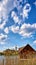 Boathouse with reeds and Schwerin Castle in the background. Vertical panorama with clouds and blue sky