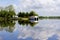 Boathouse reflected in river