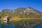 Boathouse with reflections in clean blue lake plansee at fall