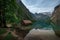 Boathouse with reflections of Watzmann mountain cliffs on lake Obersee at Berchtesgaden Bavaria