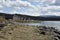 Boathouse on a row on the seashore with a mountain with snow in