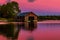 Boathouse on waters at sunset