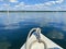 Boating on beautiful lake on blue sky and pleasant green landscape background and lovely reflection on water surface.