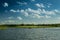 Boating on a lake beneath a blue sky