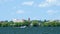 Boating in Minnesota. A Pontoon cruises on beautiful Lake Irving in Bemidji on a sunny day with blue sky and fluffy clouds.