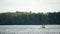 Boating in Minnesota. Water skier pulled by speed motor boat on beautiful lake.