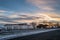 The boating pool building on the public tree lined Royal Esplanade on a winter day with snow on the ground at sunset