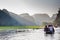 A boatman ferries tourists along the Halong Bay on land tourist attraction in Tam Coc, Vietnam.