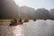 A boatman ferries tourists along the Halong Bay on land tourist attraction in Tam Coc, Vietnam.