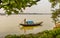 A boatman rowing Old wooden boats at the lake bank in Hooghly River Kolkata , sunny day