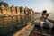 Boatmen on a boat glides through water on Ganges river along shore of Varanasi.