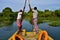 Boatmen drive boat through Buxa Tiger Reserve in West Bengal, India. A boat ride through the jungle