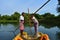 Boatmen drive boat through Buxa Tiger Reserve in West Bengal, India. A boat ride through the jungle