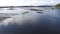 Boatmen paddle tiny wooden fishing boats on mountain lake. Drone aerial