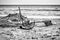 Boats anchor and fishing nets in the beach sand.