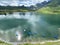 Boats on the artificial alpine lake Melchsee or Melch lake in the Uri Alps mountain massif, Melchtal - Switzerland