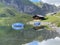 Boats on the artificial alpine lake Melchsee or Melch lake in the Uri Alps mountain massif, Melchtal - Switzerland