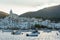 Boats in the beach and houses of the village of Cadaques, Spain