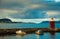 Boats and beacon in harbor. Alesund, Norway