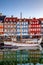 boats and beautiful historical buildings reflected in calm water, copenhagen, denmark