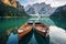 Boats on the Braies Lake in Dolomites mountains, Sudtirol, Italy