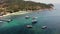 Boats in calm sea in port. Drone view of fishing and dive boats floating on tranquil surface of blue sea in harbor of tropical