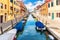 Boats in the canal and bright houses of Venice, Italy