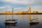 Boats in the Charles River and buildings in Back Bay at sunset,