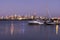 Boats, city skyline at sunset