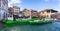 Boats collecting rubbish by crane on the Grand Canal at the Railto market in Venice, Italy