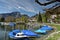 Boats covered with tarpaulin moored on Walensee lake. View of the Alps. Weesen, Switzerland