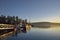 Boats at the dock in Conover Cove with a motorboat exiting at sunset, Wallace Island, Gulf Islands, British Columbia