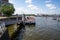 boats docked at the dock on a calm lake during a sunny day