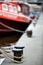 Boats docked in harbor bollards