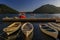 Boats docked in the postcard perfect town of Perast in Kotor Bay at sunset with mountains in the background, Montenegro