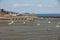 Boats on dry land at the beach at low tide in Cancale famous oysters production town, Brittany,