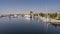 Boats and feluccas float on the smooth blue water of the Nile.