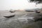 Boats of fishermen stranded in the mud at low tide on the river Malta near Canning Town, India