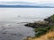 Boats fishing for salmon by trolling along the rocky shores near the kelp beds off of Sooke in the juan de fuca strait