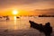 A boats is floating under colorful sky at sunset time